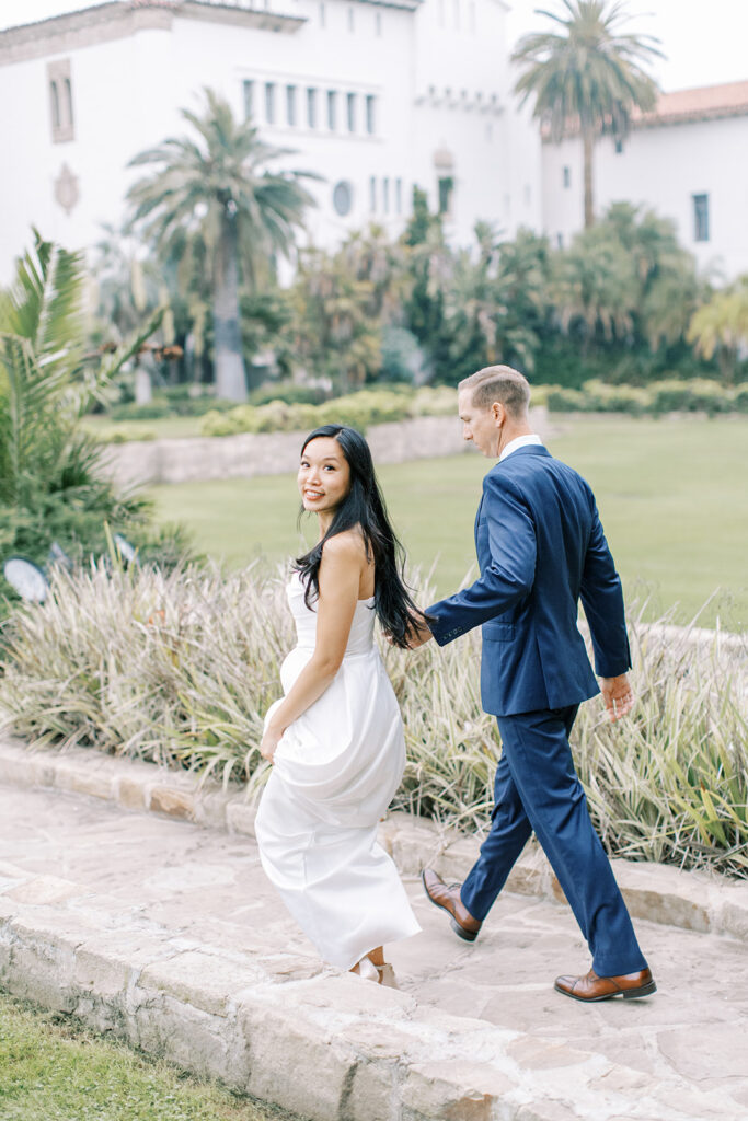 Bride and Groom walking near the Santa Barbara Courthouse Sunken Gardens